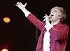 man in Chinese suit singing