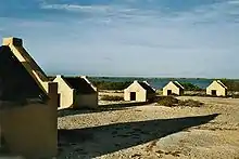 Image 23The forced African migrants brought to the Caribbean lived in inhumane conditions. Above are examples of slave huts in Dutch Bonaire. About 5 feet tall and 6 feet wide, between 2 and 3 slaves slept in these after working in nearby salt mines. (from History of the Caribbean)
