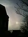 A right-hand sun dog in Salem, Massachusetts. Also visible are a Parry arc, an upper tangent arc, a 22° halo, and part of the parhelic circle.