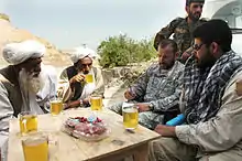 Village elders and US special forces drinking Afghan green tea (kawa) in 2007