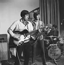Muff Winwood (on left) playing bass guitar in Amsterdam, 1966