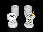3D-printed dual-use pen/toothbrush holder-cup with samples removing support material. Printed on Ultimaker 2, 2015.