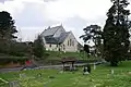 The church hall is to the left of the church