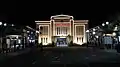 The front facade of the station at night