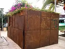 Traditional temporary Jewish Sukkah in Israel constructed out of native foliage.