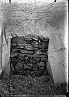 Irregular slabs of stacked stone blocking a doorway