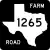 Image of FM 1265 highway shield. The square shield has a white symbol in the shape of Texas as the state appears on maps on a black background. Inside this symbol is the number 1265. The black background contains the word FARM in the upper right corner and the word ROAD in the lower left corner.