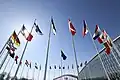 The Finnish flag waving alongside the flags of other NATO members at NATO headquarters.
