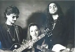Two men and a woman posing for photo