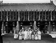 Distant photo in front of a large building