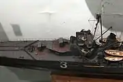 Forward 130 mm guns in superfiring single mounts 130&nbsp;mm (5.1&nbsp;in) Mle 1919 guns, main telemeter and searchlights on top of the bridge