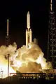 A Titan IV-B rocket lifts off after ignition of 2 SRMU boosters
