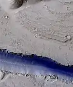 Portion of a trough (Fossae) in Elysium Planitia, as seen by HiRISE under the HiWish program. Blue indicates possible seasonal frost.