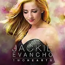Two Hearts album cover photo showing Evancho in black dress with colored clouds behind.