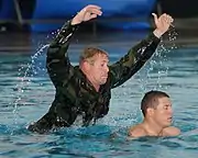 Second Phase A BUD/S instructor attacks a trainee in the pool to simulate a combative drowning victim.