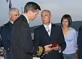 The Montenegro Minister of Defense and a U.S. Navy officer exchange gifts in 2007 during a reception to mark the first year of Montenegro's independence.