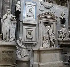 Many white stone statues and busts of writers.