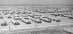 fifty plain long wooden buildings interlaced with roads