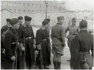 IPN copy #42Askaris assigned to the operationStroop and foreign fighters at the Umschlagplatz, with Stawki 5/7 in the back.