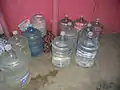 Cylindrical water jugs of the type used on water dispensers (typically around 15-30 liters).