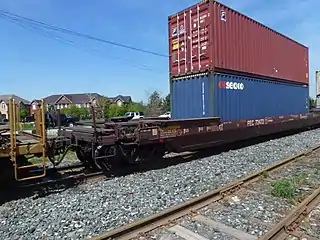 A 53-foot well car also fitted with a fifth-wheel coupling at each end to allow semi-trailer transport as well.