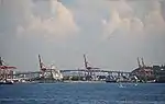An arching concrete bridge near a port
