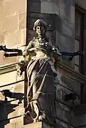 Woman holding a sewing machine, Forsyth's, corner of Princes Street and South St. Andrew's Street