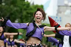 Japanese women performing a traditional Japanese dance Yosakoicode: jpn promoted to code: ja  in navel-exposing attire in the Yosakoi Matsuricode: jpn promoted to code: ja  2006 at Kōchi